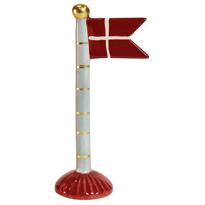 Keramisk flaggfigur med röd bas, röd/vit korsflagga och ljusblå stång med guldfärgade ränder.