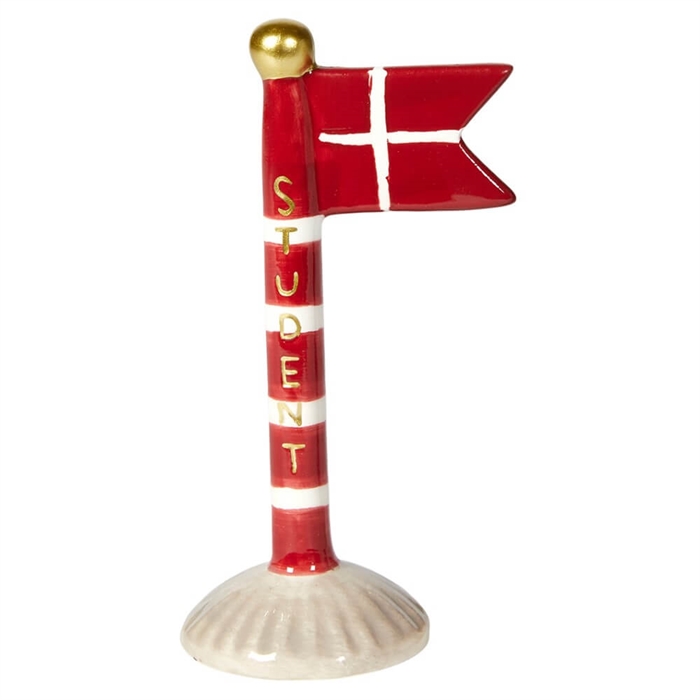Dekorativ flaggstång med röd flagga, vitt kors, gyllene boll och "STUDENT" i guld vertikalt.