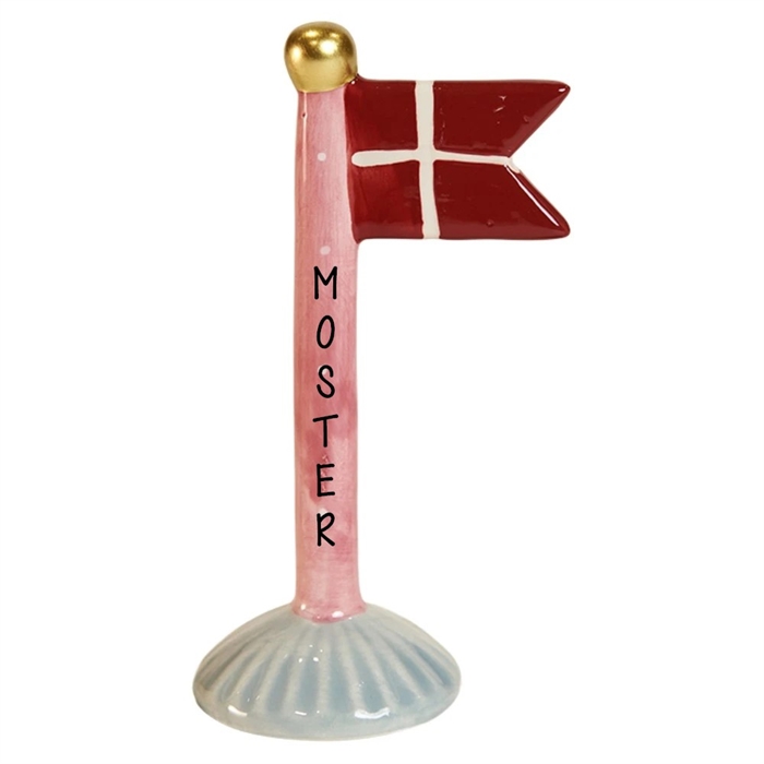 Röd flagga med vitt kors på rosa stång med "MOSTER", guldfärgad boll på toppen.
